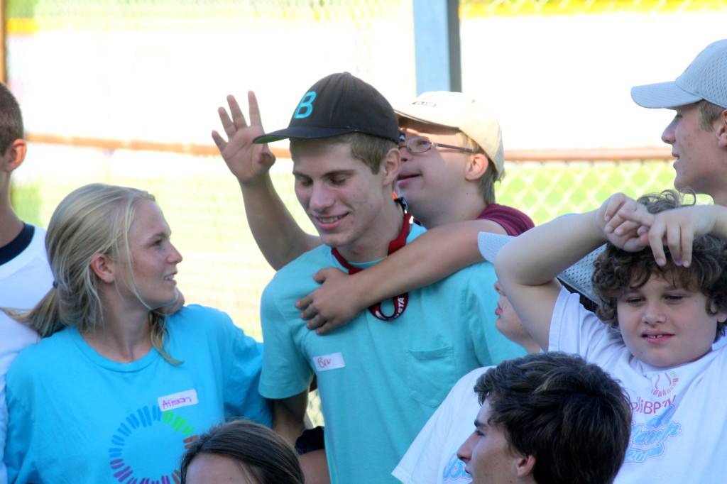 Photograph of young men and women smiling for the camera
