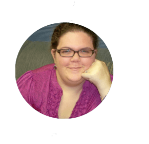 Image description: Photograph of white woman with brown hair. She is smiling and wearing brown glasses and a fuscia shirt.