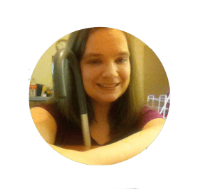 Image Description: Photograph of white woman with long brown hair holding a cane and smiling .