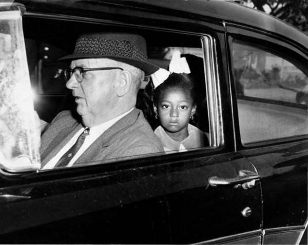 Gail Etienne age 6, one of the Mcdonogh 3, being driven to school by federal marshals looking very sad. Photo credit: NOLA.com