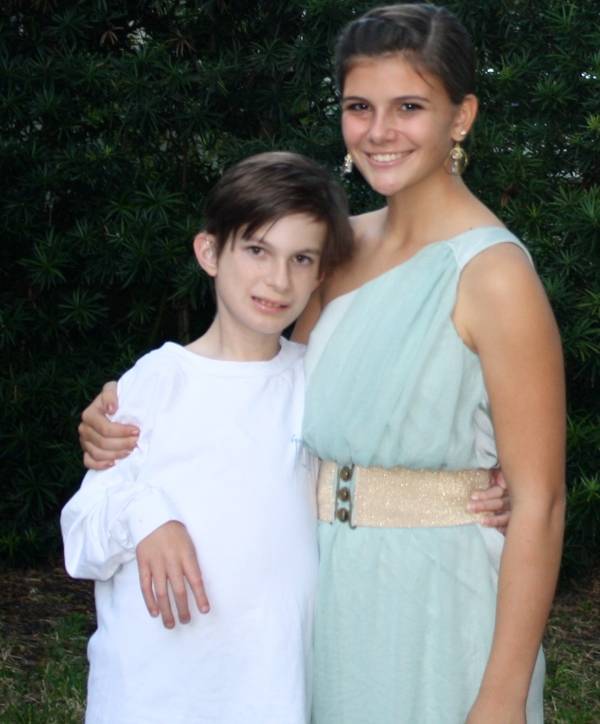 Photograph of a boy and girl looking at the camera.