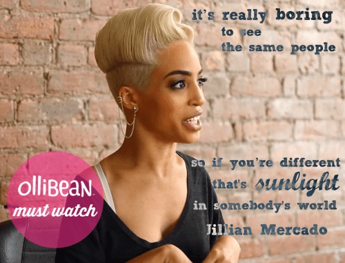 Photograph of Jillian Mercado . She has light brown skin , platinum hair and is smiling. She's wearing a black shirt. There is an exposed brick wall in the background with a pink circle with Ollibean Must Watch written inside. Dark blue script. "it’s really boring to see the same people. So if you’re different that’s sunlight in somebody’s world. " Jillian Mercado.