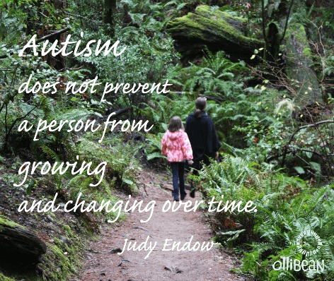 Photograph of the backs of an adult and a child walking on a path through the woods. "Autism does not prevent a person from growing and changing over time. Judy Endow" White Ollibean logo