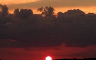 Photograph of sky and lake at sunset.