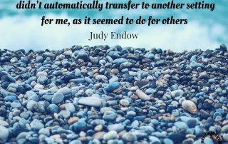 Photograph of stones on a beach. Text reads "as a child, information learned in one setting didn’t automatically transfer to another setting for me" Judy Endow on Ollibean.